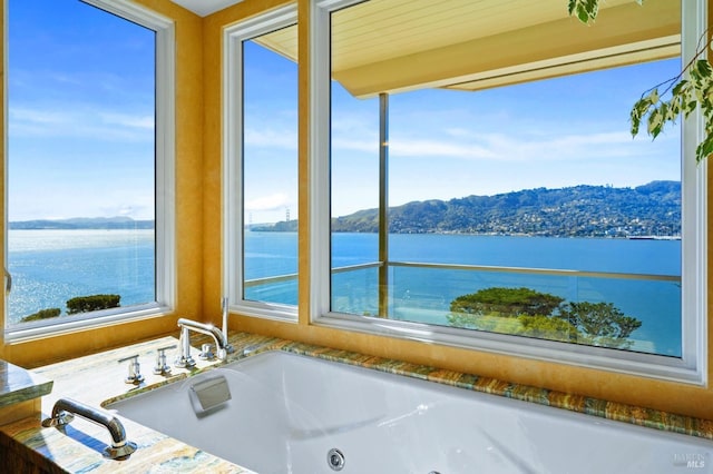 bathroom featuring a water and mountain view