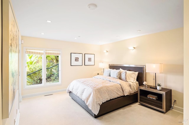 bedroom featuring light carpet