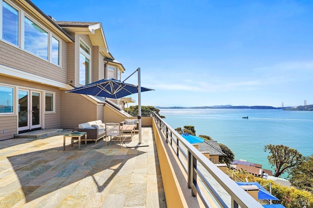 view of patio with an outdoor living space and a water view