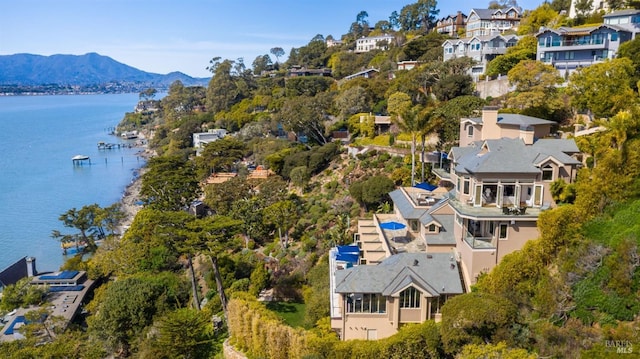 birds eye view of property with a water and mountain view