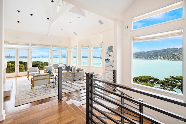 sunroom featuring a water view and a wealth of natural light