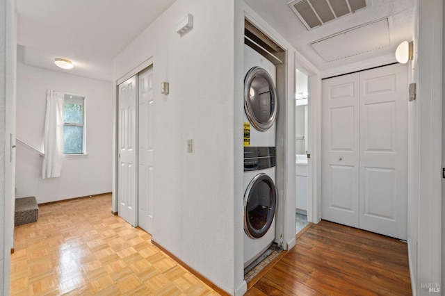 washroom featuring stacked washer and clothes dryer