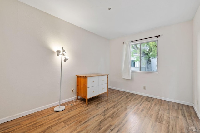 spare room featuring light hardwood / wood-style flooring