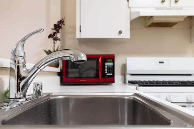 details featuring white cabinetry and white gas range oven