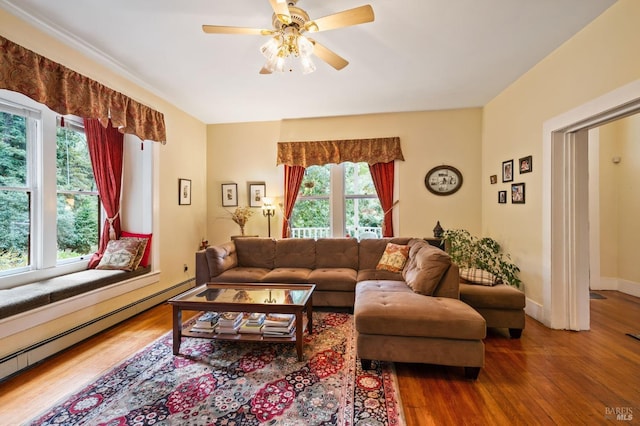 living room with ceiling fan, a baseboard radiator, wood finished floors, and baseboards