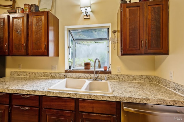 kitchen featuring a sink, light countertops, and stainless steel dishwasher