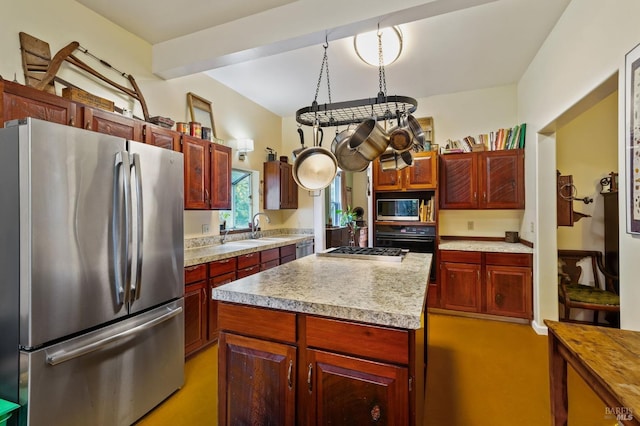 kitchen with a center island, beam ceiling, light countertops, appliances with stainless steel finishes, and a sink