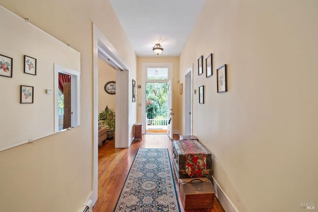 entryway with light wood-style flooring and baseboards