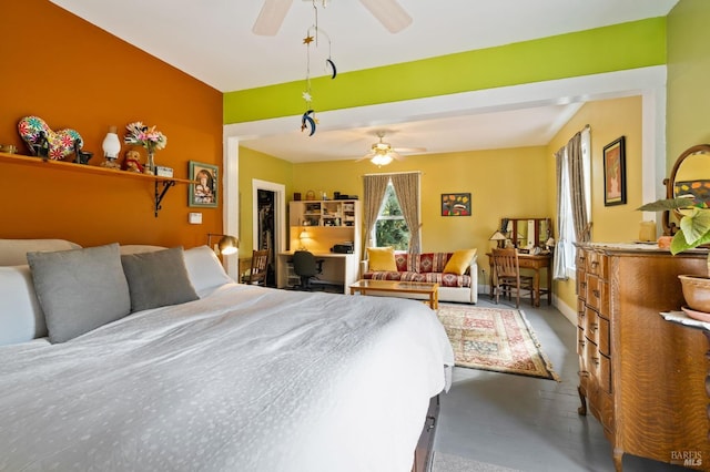 bedroom featuring concrete floors and baseboards