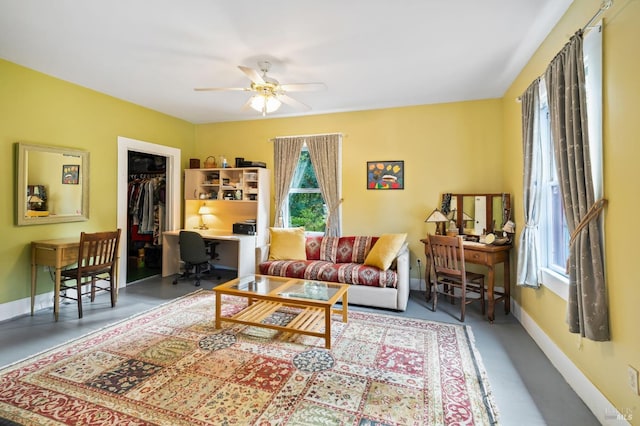 living room featuring ceiling fan and baseboards