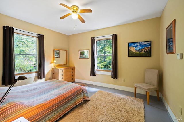 bedroom with ceiling fan and baseboards