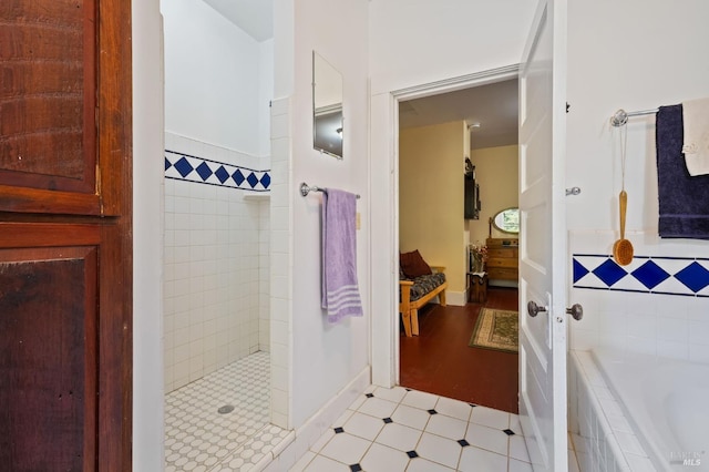 full bathroom with a garden tub and a tile shower