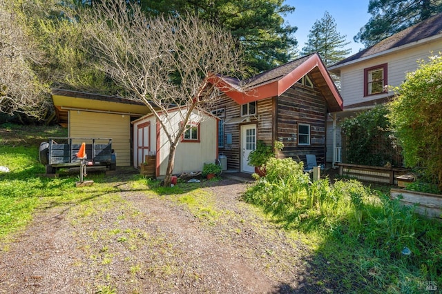 view of front of house featuring an outbuilding and a storage unit