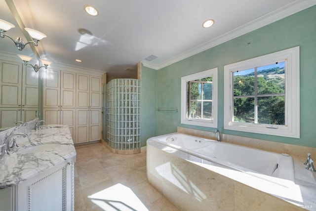 bathroom featuring tile patterned floors, crown molding, vanity, and tiled tub