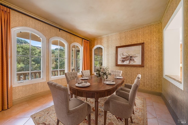 tiled dining space featuring crown molding