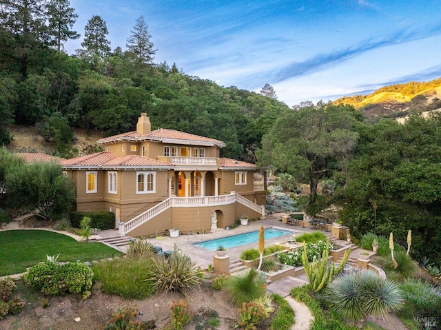 back of property with a balcony