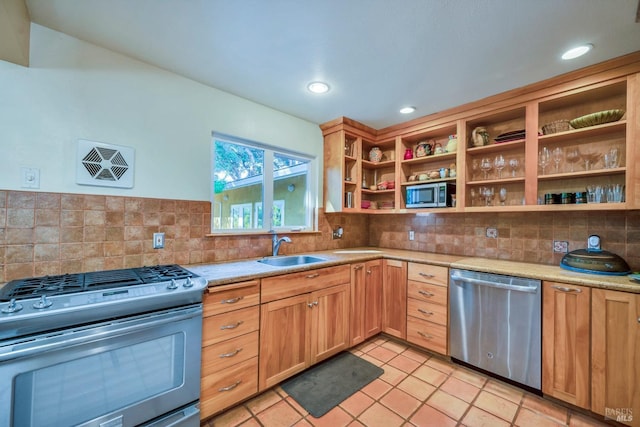 kitchen featuring decorative backsplash, light tile patterned floors, stainless steel appliances, and sink