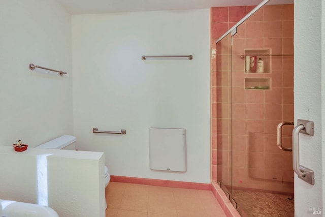 bathroom with toilet and a shower with door