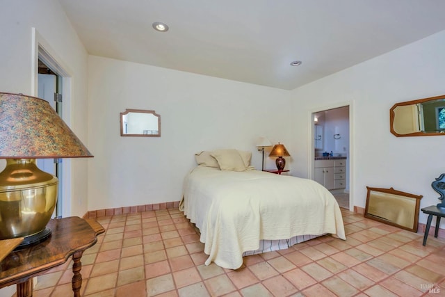 bedroom featuring ensuite bathroom and light tile patterned flooring