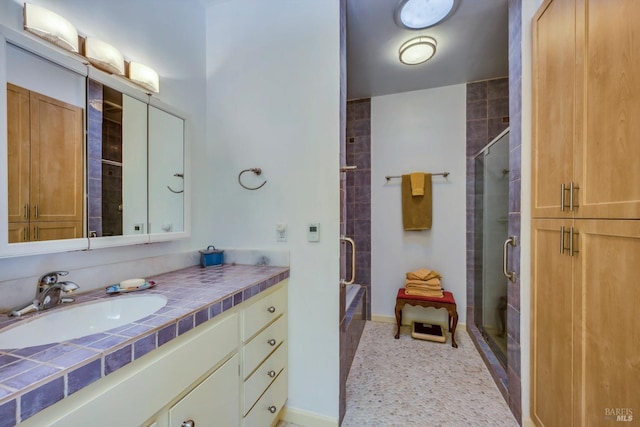 bathroom featuring vanity and an enclosed shower