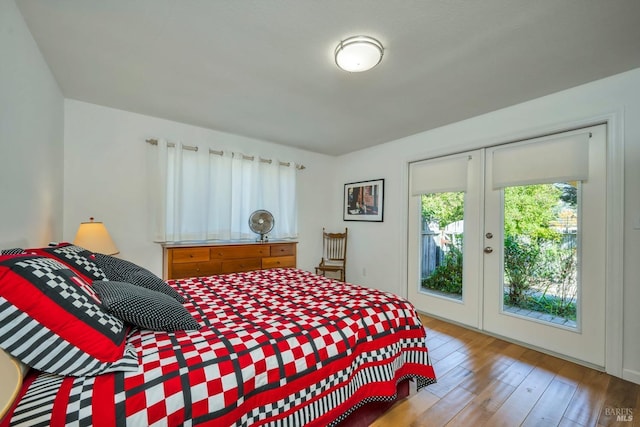 bedroom featuring french doors, access to outside, and wood-type flooring