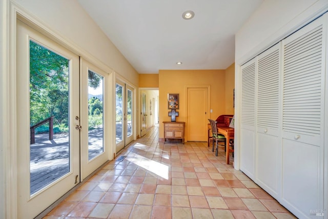 entryway with french doors and light tile patterned floors