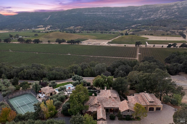 aerial view at dusk featuring a rural view