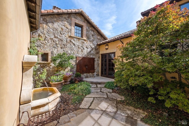 rear view of property with french doors