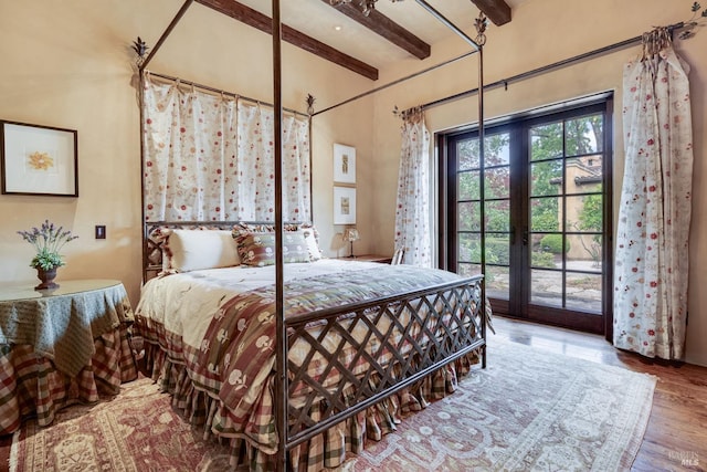 bedroom with beam ceiling, access to exterior, hardwood / wood-style flooring, and french doors