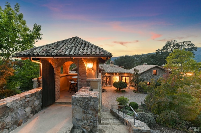 view of front of property with a patio area and exterior bar