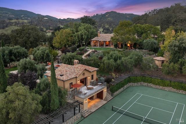 aerial view at dusk featuring a mountain view