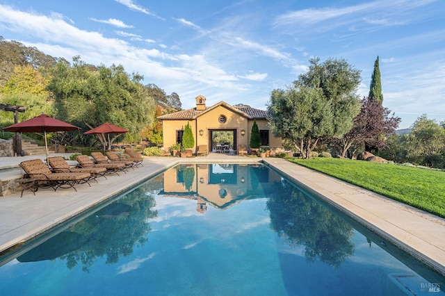 view of pool with a yard and a patio area