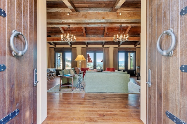 living room with beam ceiling, wood walls, and wood-type flooring