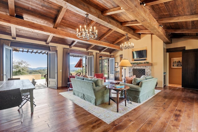 living room featuring a barn door, wood ceiling, wood-type flooring, and lofted ceiling with beams