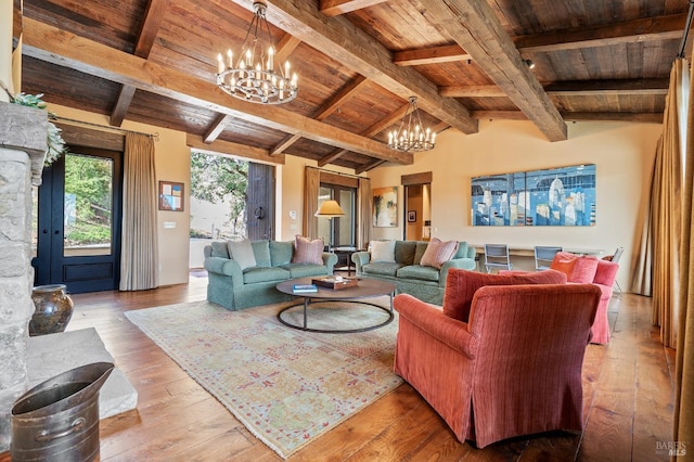 living room with vaulted ceiling with beams, an inviting chandelier, wooden ceiling, and light wood-type flooring