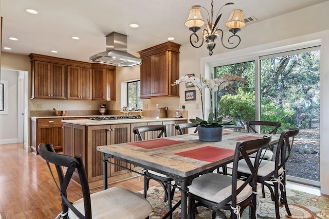 dining room featuring an inviting chandelier and light wood-type flooring