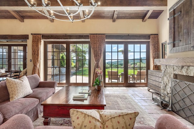 living room with a wealth of natural light, beamed ceiling, and french doors