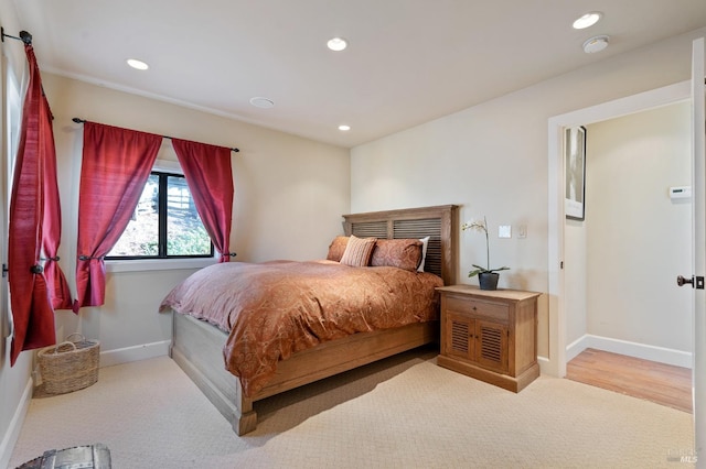 bedroom featuring light colored carpet