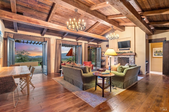 living room with wood ceiling, dark hardwood / wood-style floors, lofted ceiling with beams, and a barn door