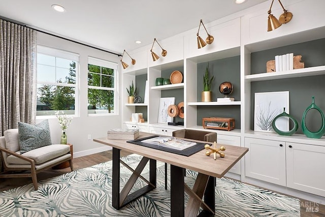 office space with built in shelves, recessed lighting, dark wood finished floors, and baseboards