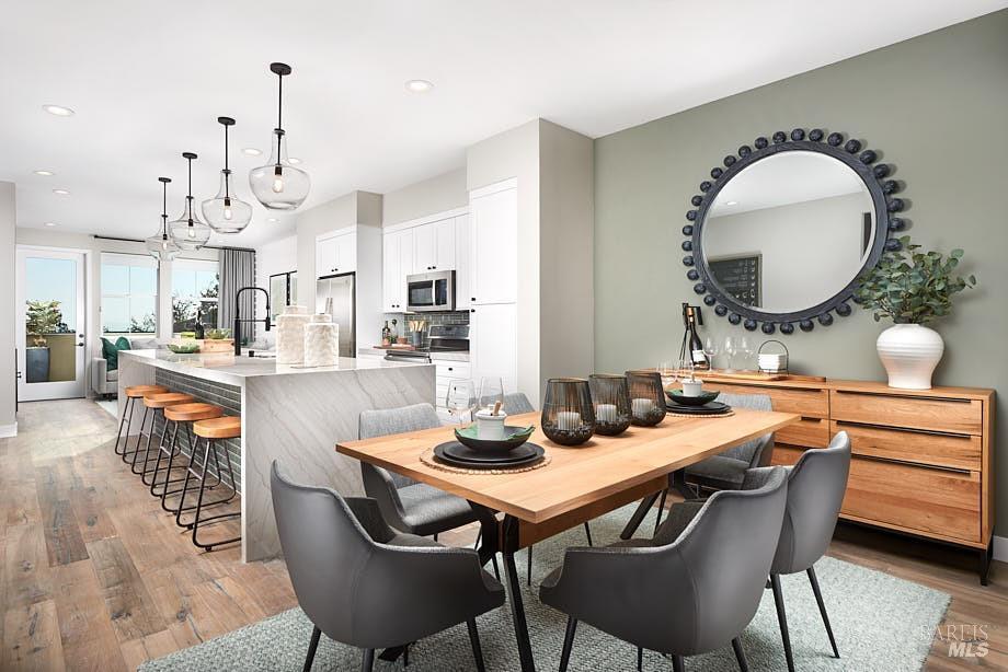 dining room with light wood finished floors and recessed lighting