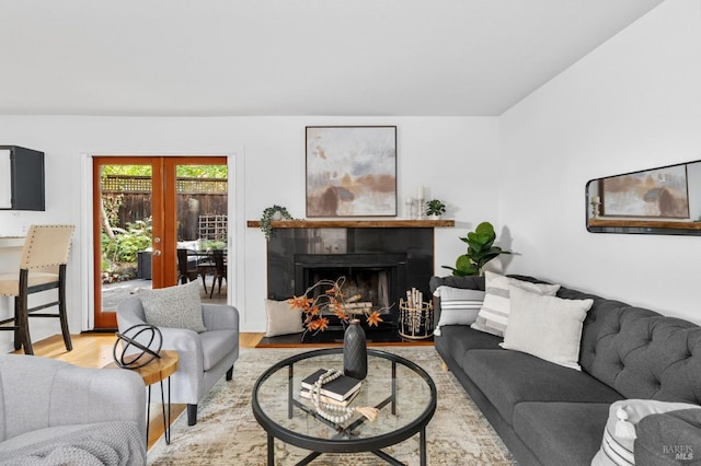 living room with french doors and light hardwood / wood-style floors