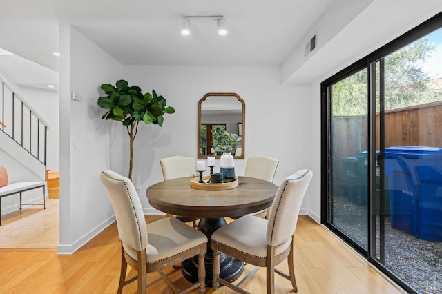 dining space with light wood-type flooring