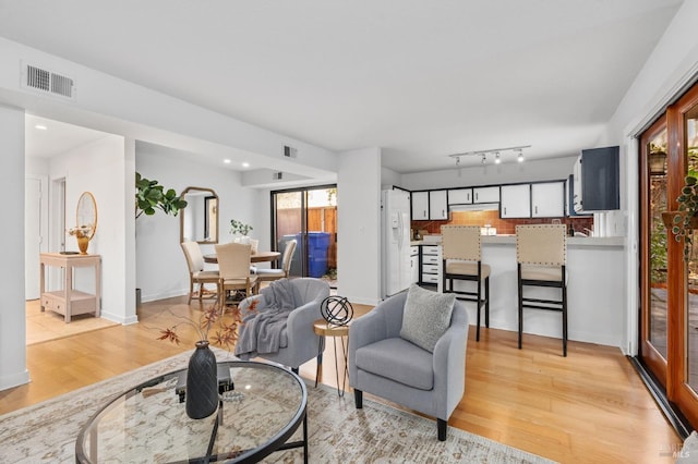 living room with light hardwood / wood-style flooring