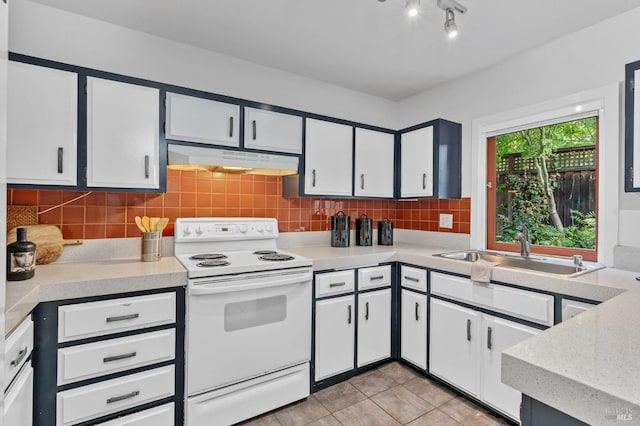 kitchen with backsplash, sink, white range with electric cooktop, light tile patterned floors, and white cabinetry