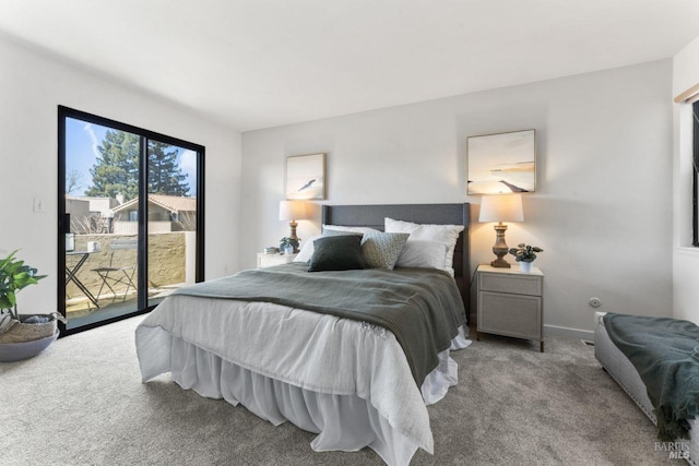 carpeted bedroom with baseboards and access to exterior