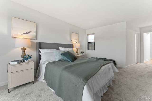bedroom with carpet floors and baseboards