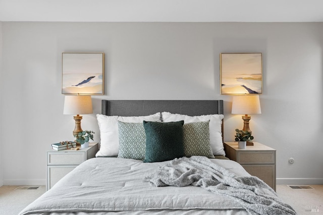 carpeted bedroom with baseboards and visible vents