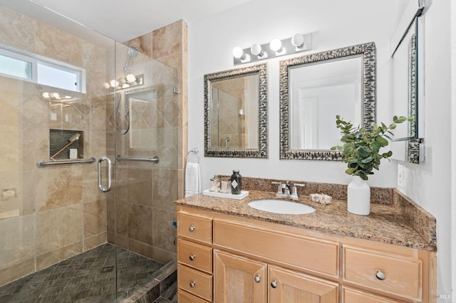 bathroom with vanity and a shower with shower door