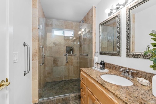 bathroom with vanity and a shower with shower door